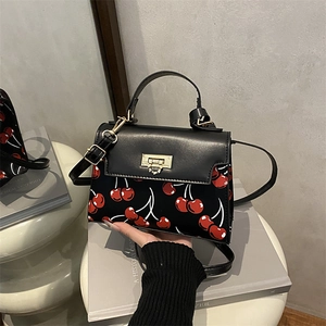 Retro black leather handbag with red cherry print and golden square twist lock