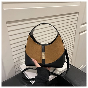 Detail of suede handbag with leopard pattern and gold metal buckle for women