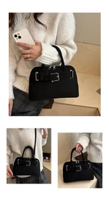 Detail of black vintage shell bag featuring silver metal buckle and soft matte texture