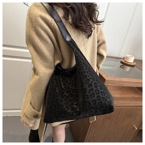 Large black leopard print tote bag styled with a winter wool coat for casual wear