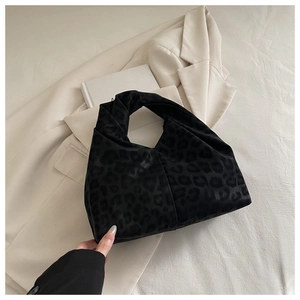 Close-up of leopard print velvet cloud handbag with unique knotted handle design