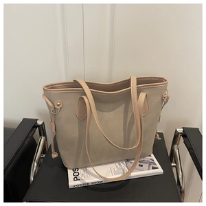 Detail view of large matte tote bag with golden ring hardware and decorative knot