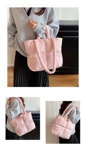 Detail view of pink quilted down cotton tote bag with soft padded handle and waterproof texture