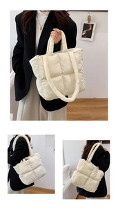 Detail view of cream quilted puffer tote bag with square stitching and crossbody strap