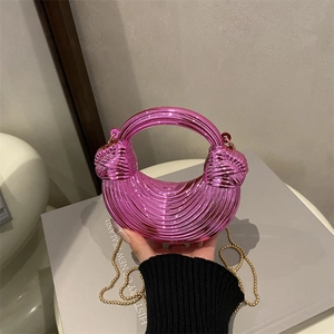 Metallic pink crescent handbag with wavy texture, round handle and gold chain strap