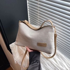 Canvas and leather patchwork shoulder bag in beige and tan with gold hardware