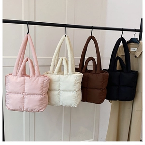 Detailed display of four quilted puffer tote bags in pink, beige, brown, and black colors