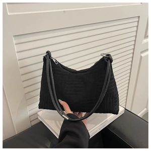 Détail du sac bandoulière en velours côtelé noir avec texture géométrique et zip argenté