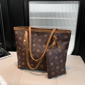 Brown tote bag and matching pouch with diamond pattern on white bench in modern interior