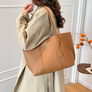 Retro camel tote bag with large capacity for commuting shown on a model in an autumn setting