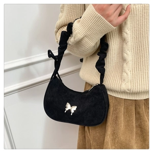 Detail shot of black crescent underarm bag with silver butterfly and scrunchie handle