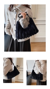 Detail of black plush shoulder bag featuring soft striped texture and slim strap
