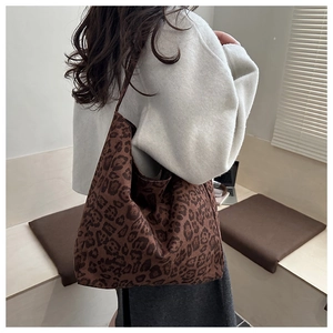 Close-up of a leopard print tote bag in brown and black with soft fabric texture