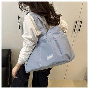 Close-up of large canvas tote bag with side pocket and Fashion label for women