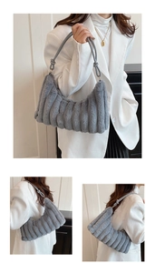 Detailed close-up of light gray plush shoulder bag featuring vertical quilted faux fur texture
