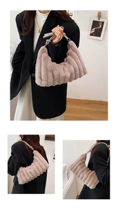 Detail showing the plush pink faux fur bag with vertical stripes and knotted shoulder strap