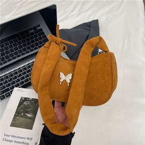 Caramel suede shoulder bag with silver butterfly buckle and knot strap detail
