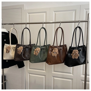Detail shot of stylish commuter tote bags in five colors with cute bear charms
