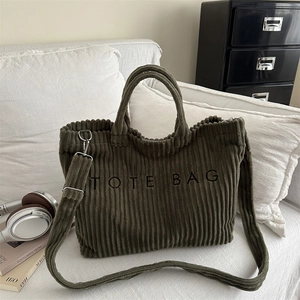 Dark green corduroy tote bag with TOTE BAG embroidery and adjustable shoulder strap