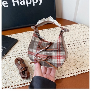 Detail of vintage plaid mini crescent bag with double leather bows and lace trim handle
