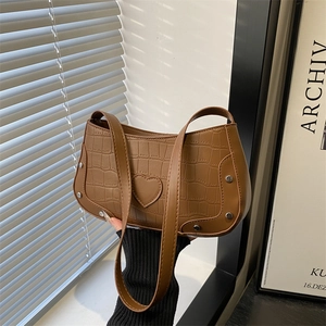 Brown crocodile texture shoulder bag with heart patch and silver rivets details