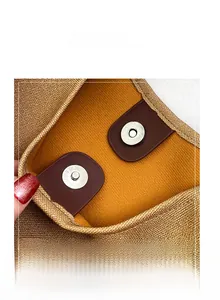 Close-up of high-quality magnetic hardware closure and mustard yellow lining of tote bag