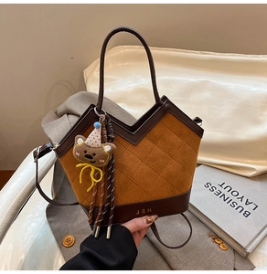 Détail du sac bandoulière léopard avec surpiqûres losanges et breloque ours