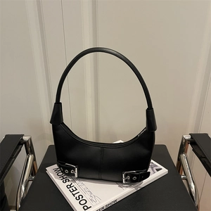 Minimalist black crescent shoulder bag with silver belt buckle and curved handle