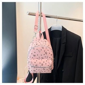 Dettaglio mini zaino in velluto rosa con stampe a cuore e cerniere in metallo argento