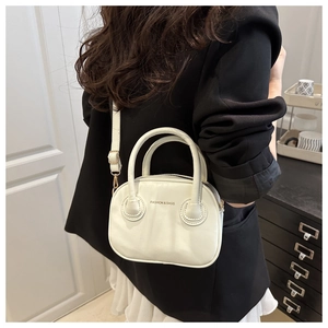 Detailed view of white PU leather mini bowling bag with gold hardware and shoulder strap