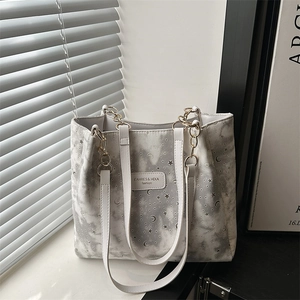 Stylish canvas tote bag with star and moon prints and golden chain handle decoration