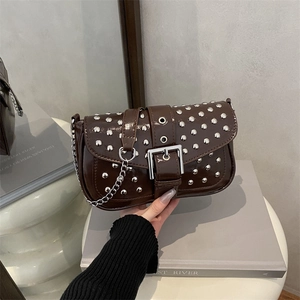 Brown patent leather shoulder bag with silver studs and chain strap on display stand