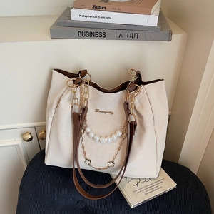 Chic cream tote bag with pearl chain decoration and brown straps for office commute