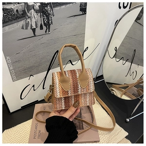 Detail shot of the woven wave pattern and retro PU handle on this stylish mini square bag