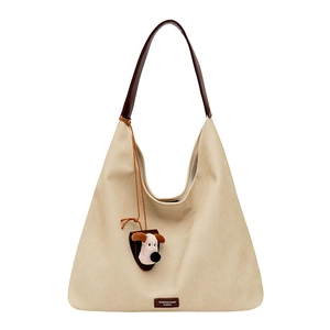 Minimalist beige canvas hobo tote bag with brown leather handle and cute puppy pendant