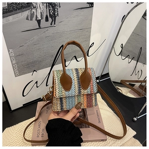 Close-up of rainbow zigzag woven texture on mini crossbody bag with leather handle