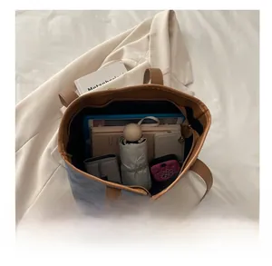 Detail view of large tote bag interior showing spacious capacity for tablets and essentials