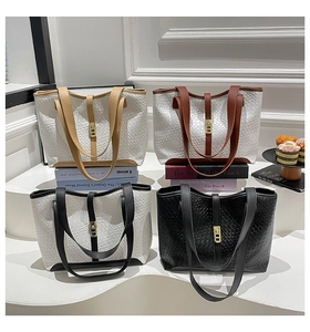 Detail of woven texture tote bags in four colors with gold metal buckles and slim straps