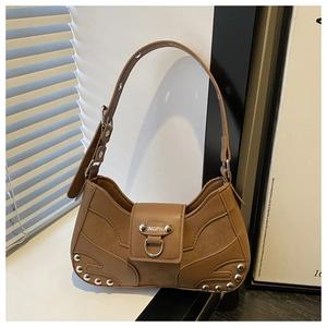Detail view of brown PU leather and suede patchwork shoulder bag with silver rivet studs