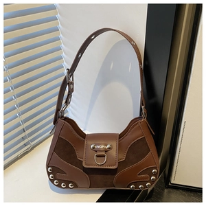 Detailed close-up of brown leather stitching and silver rivet accents on shoulder bag