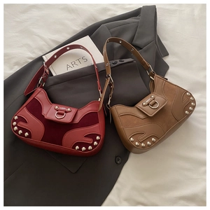 Detail of vintage rivet shell bags in burgundy and brown with metallic hardware