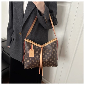 Detailed view of the structured tote bag base with protective metal studs and leather trim
