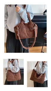 Detail of brown corduroy tote bag featuring black embroidered lettering and shoulder strap