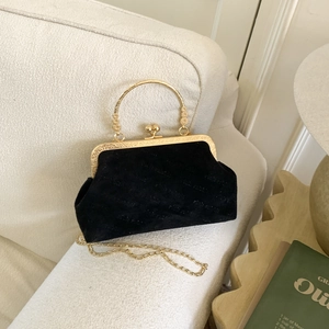 Elegant black suede shell-shaped chain bag with gold handles and rich rabbit lettering