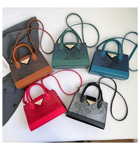 Detailed array of five textured snake-pattern crossbody bags in various trendy colors