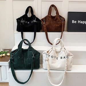 Corduroy tote bags in four colors with shoulder straps and minimalist lettering design