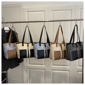 Row of minimalist large tote bags in five colors with metal buckle and shoulder straps