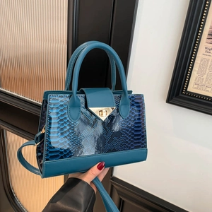 Blue faux snake skin crossbody handbag with gold triangle clasp for stylish women