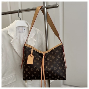 Close-up of vintage geometric pattern and leather tag on large brown tote bag