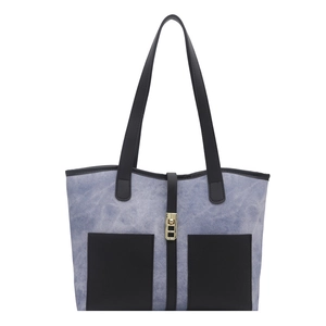 Blue denim patchwork tote bag with black leather pockets and gold buckle closure